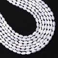 Macro detail of natural mother of pearl shell beads with elegant wavy texture - White