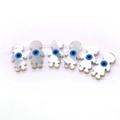 Macro detail of doll-shaped seashell beads featuring blue evil eye patterns for DIY jewelry - Little Girl Shape / 5 Pieces/Pack (8x15mm) / White (Blue Eye)