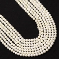 Faceted white round beads for DIY jewelry making with smooth glossy finish on dark background - 2.0mm / Artificial Pearl White