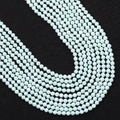 Macro shot of faceted mint green turquoise beads showing detailed multi-surface cut for jewelry - 2.0mm / Mint Green
