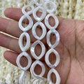 Macro detail of natural mother of pearl shell beads with elegant oval hollow design - Hollow Marquise Style (Size 8) / 13x18mm
