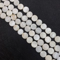 Macro view of flat round natural white shell beads with iridescent luster for DIY jewelry - Round
