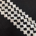 Macro shot of clover-shaped white mother of pearl shell beads with natural pearly luster - Four-Petal Flower