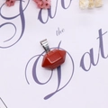 Macro shot of red jasper stone pendant with geometric facets and silver clasp - Red Jasper Variation