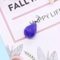 Macro shot of faceted blue teardrop gemstone pendant on a decorative art card - 13x23mm / Blue Chalcedony