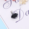 Polished black onyx hexagonal pendant with silver clasp on elegant decorative card - Black Agate
