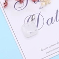 Square natural white quartz stone pendant with silver bail on a light blue background - White Crystal