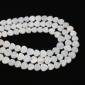 Macro detail of moon shaped natural shell beads with iridescent luster for DIY jewelry - Vertical Hole Heart Shape
