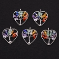 Detailed view of five heart-shaped tree of life pendants with rainbow natural stones - Colorful