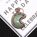 Close-up of crescent moon natural stone pendant with vintage copper plated frame detail - 4.3cm x 5.5cm / Green Aventurine