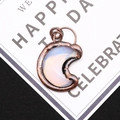 Macro shot of crescent moon opal pendant with antique copper electroplated frame detail - 4.3cm x 5.5cm / Opal