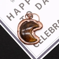 Macro shot of tiger eye stone moon pendant with bronze plating and textured metal edges - 4.3cm x 5.5cm / Tiger's Eye