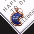 Macro shot of crescent lapis lazuli pendant with vintage copper plated metal frame - 4.3cm x 5.5cm / Lapis Lazuli
