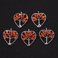 Silver tree of life heart pendants with reddish-brown sunstone chips on black background - Gold Sandstone