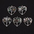 Five heart-shaped Tree of Life pendants with colorful natural stones on black velvet - India Agate