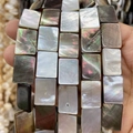 Macro detail of natural square shell beads with iridescent pearl luster for jewelry making - Rectangle / 15x20