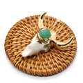 Cow skull pendant in white resin with gold trim and a green stone on woven mat - White Base Green Crystal (Style 1)