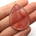 Teardrop stone pendant with red and white marble patterns in a gold plated frame - Watermelon Quartz