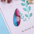 Macro detail of teardrop synthetic turquoise pendant with blue and magenta veined texture - 16x42mm 9g / US 8
