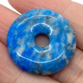 Handheld view of a blue and white mottled natural K2 stone donut pendant for DIY jewelry - Blue and White Textured K2 Stone (No. 2)