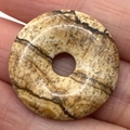 Polished natural picture jasper stone pendant in a round donut shape with unique textures - Picture Jasper
