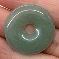 Natural light green jadeite donut pendant with a smooth polished finish and subtle texture - Green Aventurine