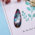 Macro detail of teardrop natural stone pendant with colorful mosaic textures and pre-drilled hole - 16x42mm 9g / US 14