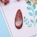 Polished teardrop natural stone pendant with dark mineral textures on a decorative background - 16x42mm 9g / Size 18