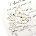 Close-up of white shell-textured round charms with golden lightning bolt inlay details - Flash / 6mm 20g 20 Pcs/Pack