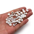 White shell bead with silver starfish charm shown on hand for DIY jewelry making - 6mm / 20 Pcs/Pack / Starfish