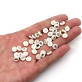 Flat round white shell beads with owl pattern held in hand for jewelry making - Owl / 6mm (20 Pieces)