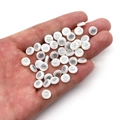 Hand holding 6mm white shell beads with silver tree of life charms for DIY jewelry making - 6mm / 20 Pcs/Pack / Tree of Life