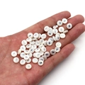 Handheld view of 6mm white shell beads with silver lightning bolt for DIY jewelry - 6mm / 20 Pcs/Pack / Flash