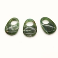 Macro shot of three teardrop-shaped natural opal stone pendants with polished green texture - Moss Agate