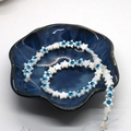 Perles en forme d'étoile en coquillage avec motif œil bleu sur une assiette en céramique - Étoile / 8mm (env. 14g/Brin)