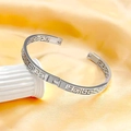 Silver magnetic therapy cuff bracelet with Greek fret pattern on elegant white pedestal - 18K Gold / Silver
