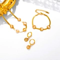 Macro shot of 18k gold plated flat snake chain jewelry set with cat-eye stones - Necklace Bracelet and Earring Set / White