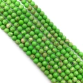Polished round imperial jasper beads in vibrant green with natural mottled brown textures - Size 12