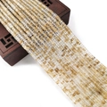 Gouden rutielkwarts kralen 2x4mm gedrapeerd op een vintage donkerhouten sieradendoosje - 2x4mm / Rutilated Kwarts Goud