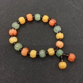 Detailed macro view of pumpkin-shaped natural agate beads in orange, yellow and green - No. 1 - Orange Yellow Green Purple Multi-Color