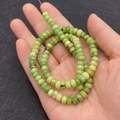 Handheld view of 4x6mm apple green rondelle imperial stone beads for DIY jewelry - 4x6MM / Size 7