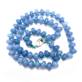Handmade beaded necklace with light purple abacus stones and vibrant teal knots - Synthetic Aquamarine
