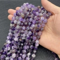 Faceted natural purple amethyst loose beads held by hand for DIY jewelry making - Amethyst