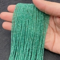 Strand of faceted green cat eye stone beads 2mm size held in hand for scale - No. 12 (Emerald Green)