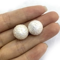 Macro detail of hand-held natural freshwater pearls with unique sunburst carved patterns - 12-13mm / White (No Hole)