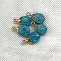 Detailed close-up of five teardrop-shaped turquoise stone charms with gold-plated caps - 10x17mm / Blue Turquoise Gold