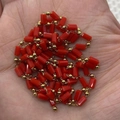 Hand holding red cylindrical coral beads with golden metal spacers for jewelry DIY - 3x5mm / Red (5#)