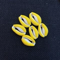 Vibrant yellow and white cowrie shell beads on black fabric for DIY jewelry making - 13x20mm / Yellow