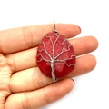 Handmade silver wire-wrapped tree of life pendant with red agate stone on hand - Red