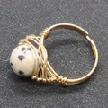 Handmade wire wrapped ring featuring a 10mm Dalmatian jasper bead in a golden finish - Dalmatian Jasper